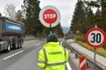 Road supervisor from behind with stop sign - road block due to a construction site in Salzkammergut, Austria, Europe